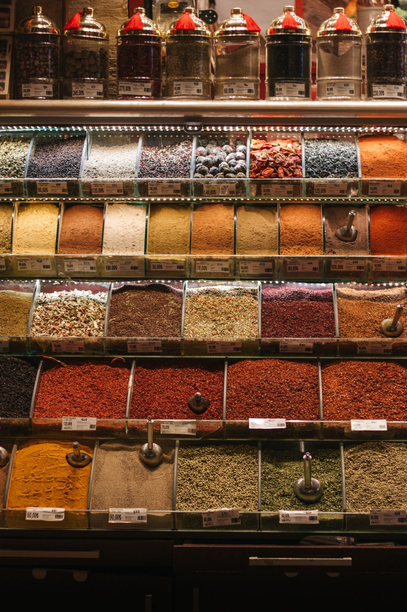 Vibrant spices in a market stall showcase a variety of flavors and colors.